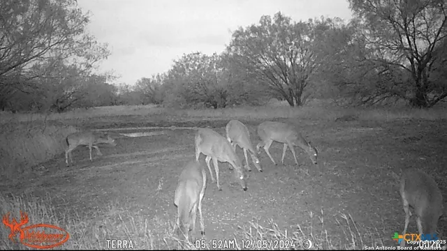 a en suite bathroom with a granite countertop sink and a mirror