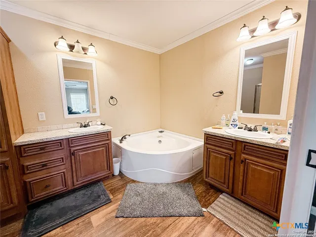 a bathroom with a granite countertop sink mirror and bathtub