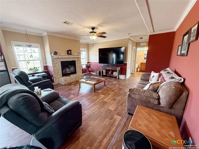 a living room with furniture a flat screen tv and a fireplace