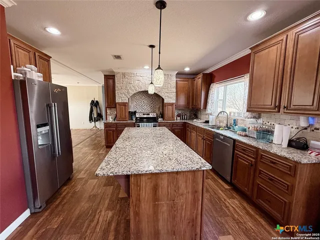 a kitchen with sink refrigerator and window