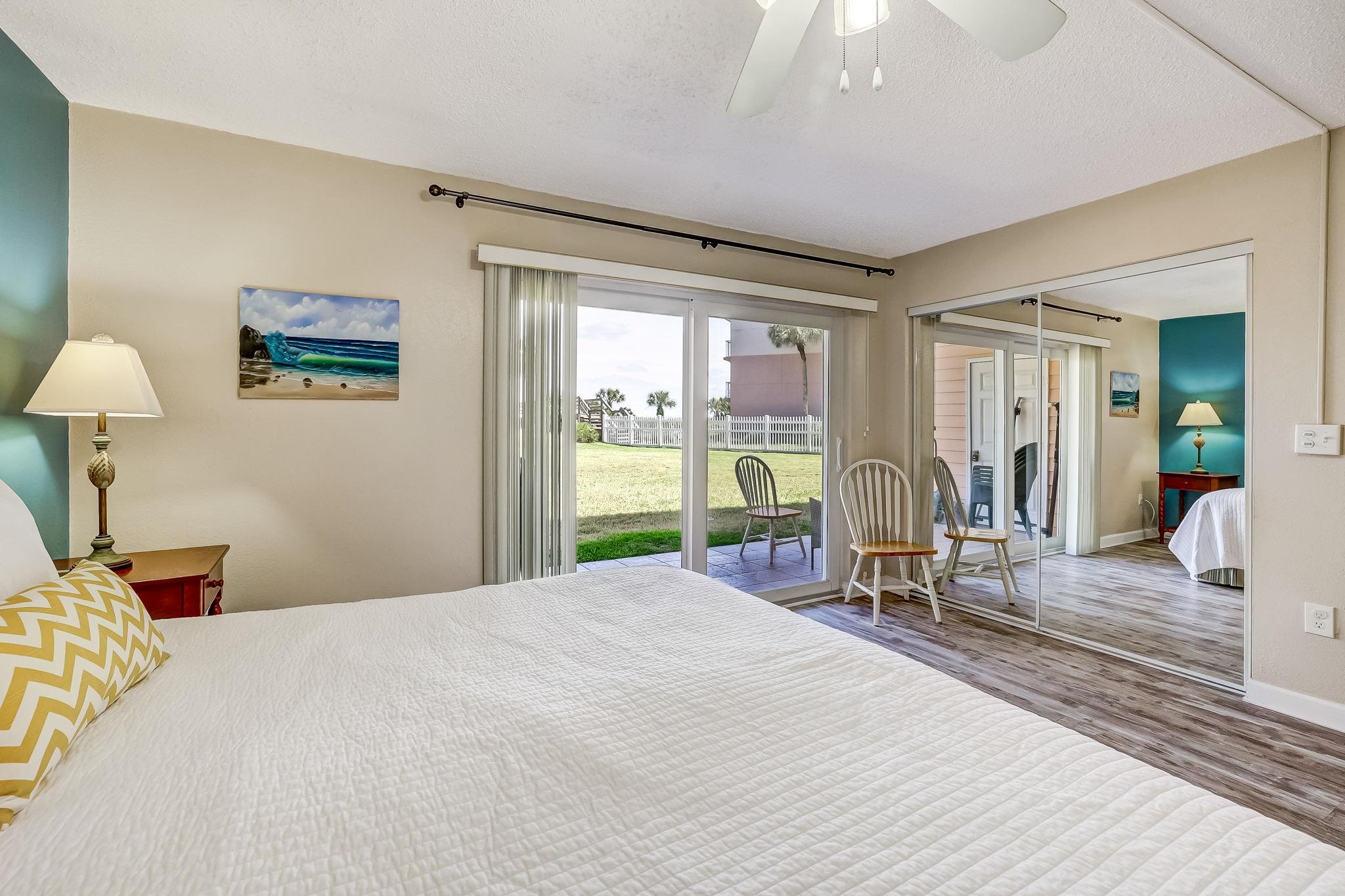 4 Ocean Trace Road, Unit 108 St. Augustine, FL 32080 - Photo 17 of 54 a bedroom with a bed a table and chair