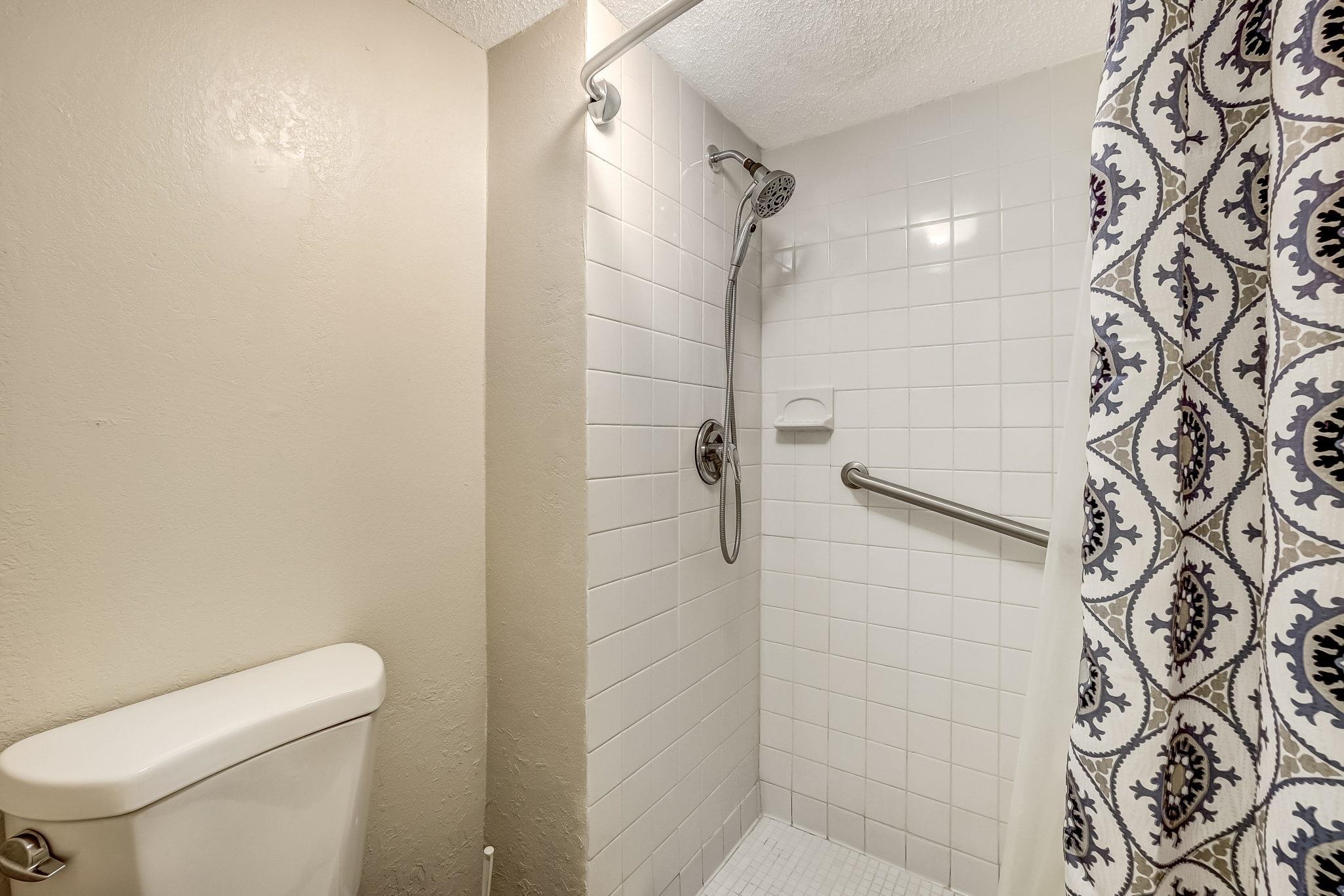 4 Ocean Trace Road, Unit 108 St. Augustine, FL 32080 - Photo 19 of 54 a white toilet sitting next to a shower curtain