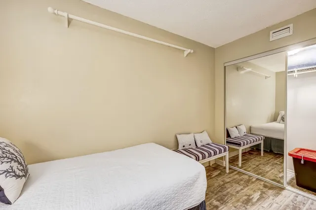 a bedroom with a bed and a chair