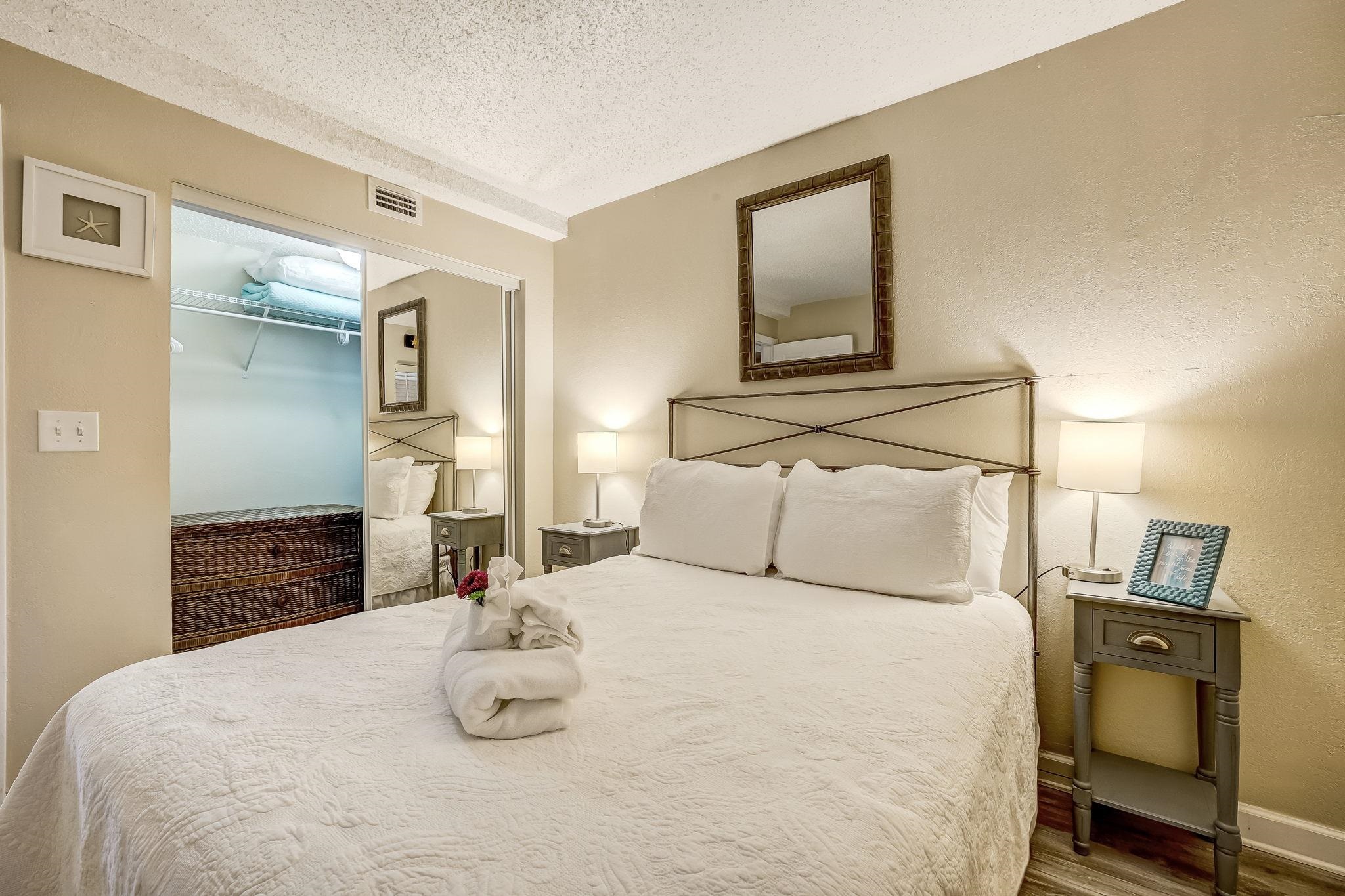 4 Ocean Trace Road, Unit 108 St. Augustine, FL 32080 - Photo 24 of 54 a bedroom with a bed and wooden floor