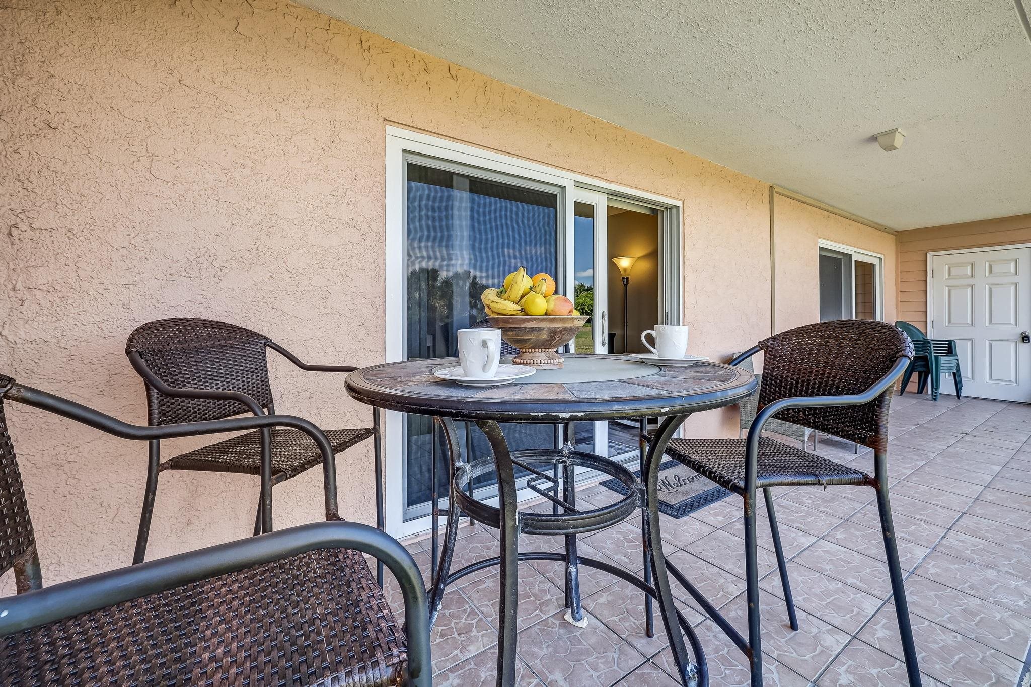 4 Ocean Trace Road, Unit 108 St. Augustine, FL 32080 - Photo 27 of 54 a view of a dining room with furniture and wooden floor