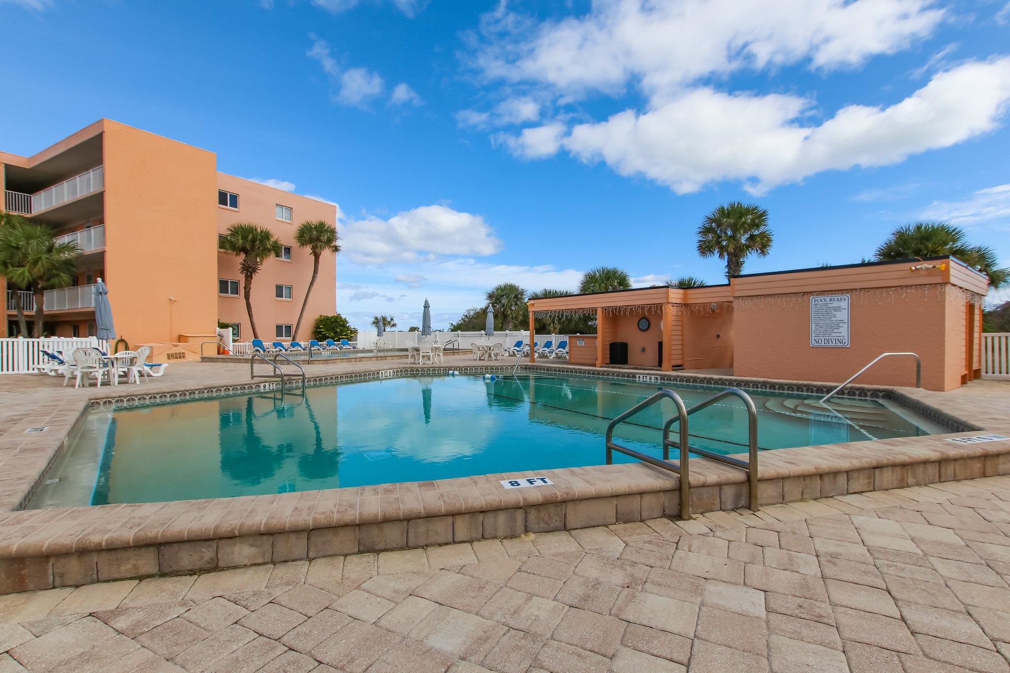 4 Ocean Trace Road, Unit 108 St. Augustine, FL 32080 - Photo 36 of 54 a view of a swimming pool with a lounge chairs