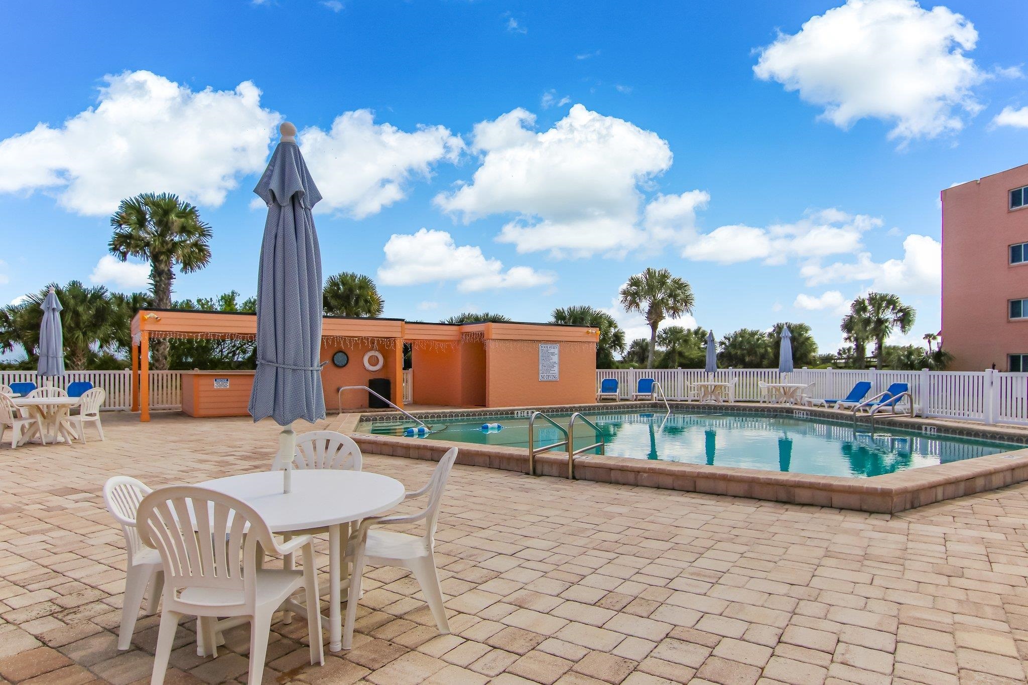 4 Ocean Trace Road, Unit 108 St. Augustine, FL 32080 - Photo 38 of 54 a balcony with table and chairs