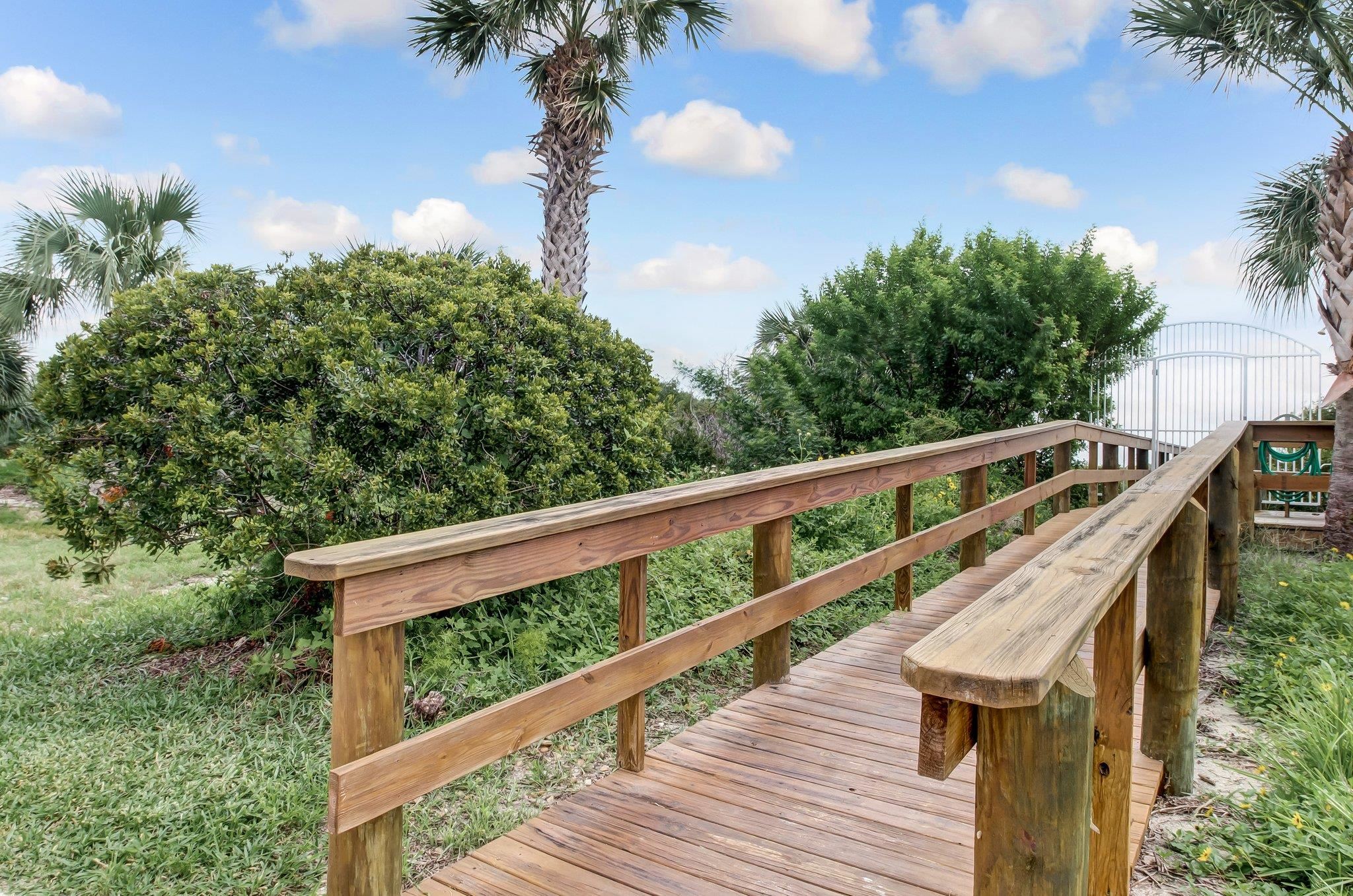 4 Ocean Trace Road, Unit 108 St. Augustine, FL 32080 - Photo 43 of 54 a balcony with wooden floor and fence