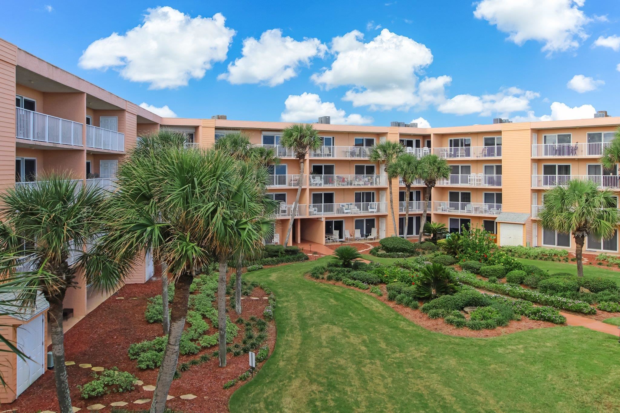 4 Ocean Trace Road, Unit 108 St. Augustine, FL 32080 - Photo 47 of 54 a view of a building and yard with large trees