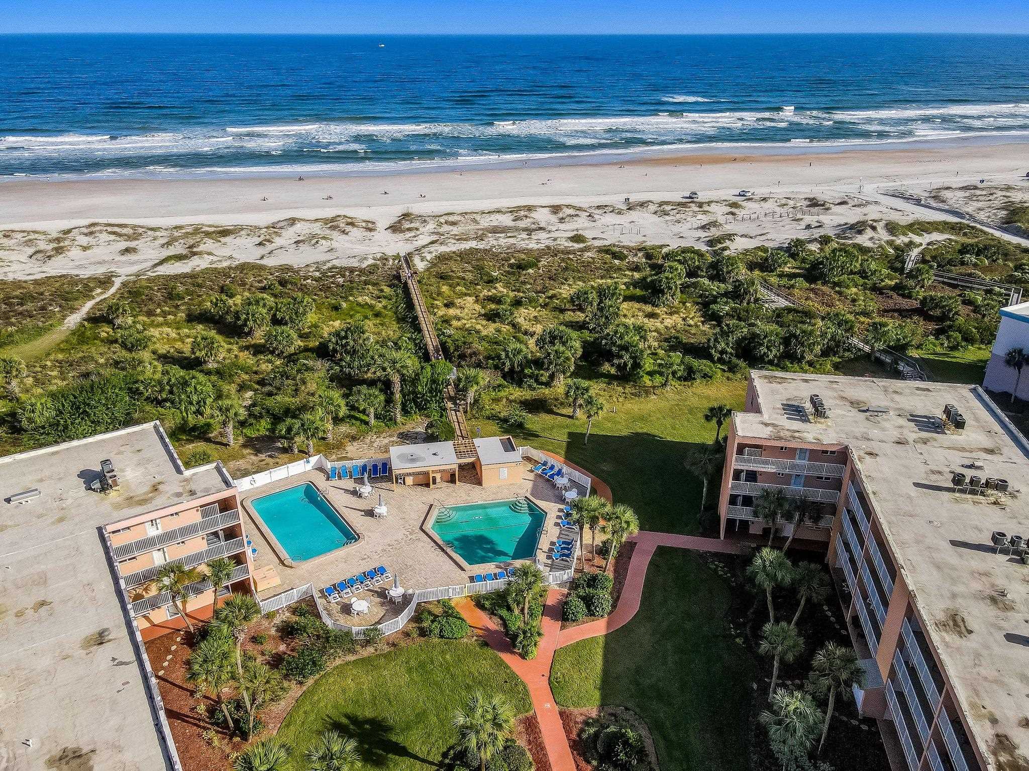 4 Ocean Trace Road, Unit 108 St. Augustine, FL 32080 - Photo 50 of 54 Bird's eye view of a pool area and waterfront with a beach