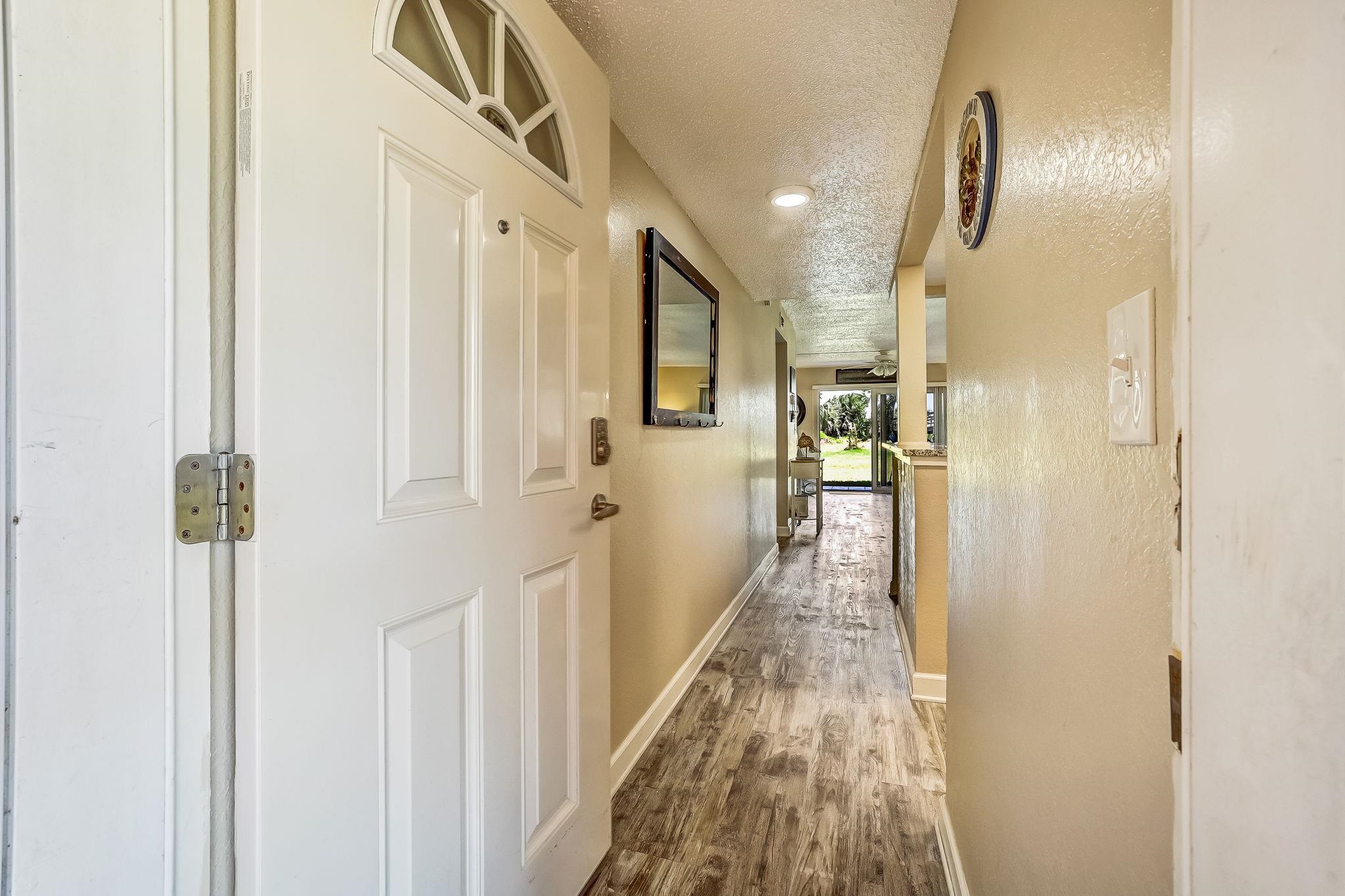4 Ocean Trace Road, Unit 108 St. Augustine, FL 32080 - Photo 6 of 54 a view of hallway with wooden floor