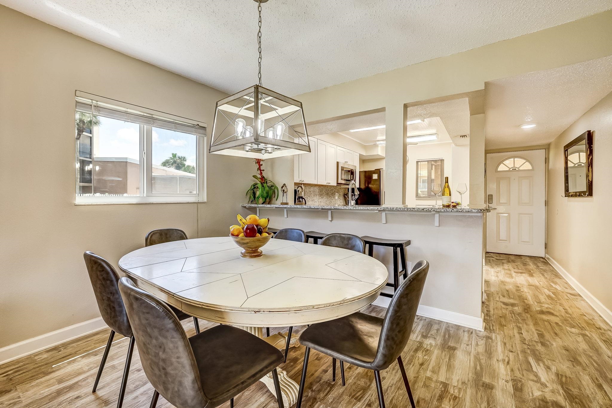 4 Ocean Trace Road, Unit 108 St. Augustine, FL 32080 - Photo 10 of 54 a view of a dining room with furniture window and wooden floor