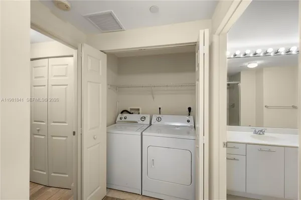 a view of bathroom with a washer and dryer