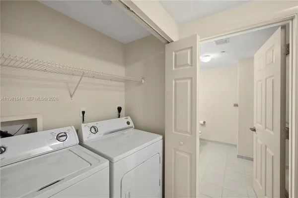 a view of storage and utility room with washer and dryer