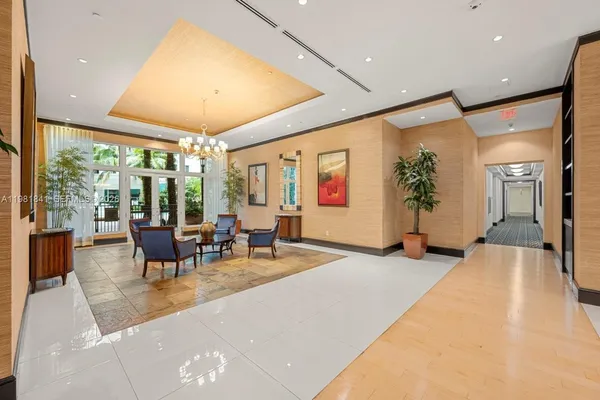 a living room with furniture and large windows