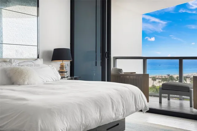 a bedroom with a bed and glass windows