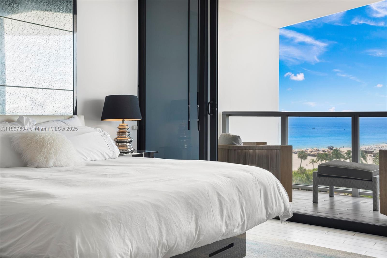 a bedroom with a bed and glass windows