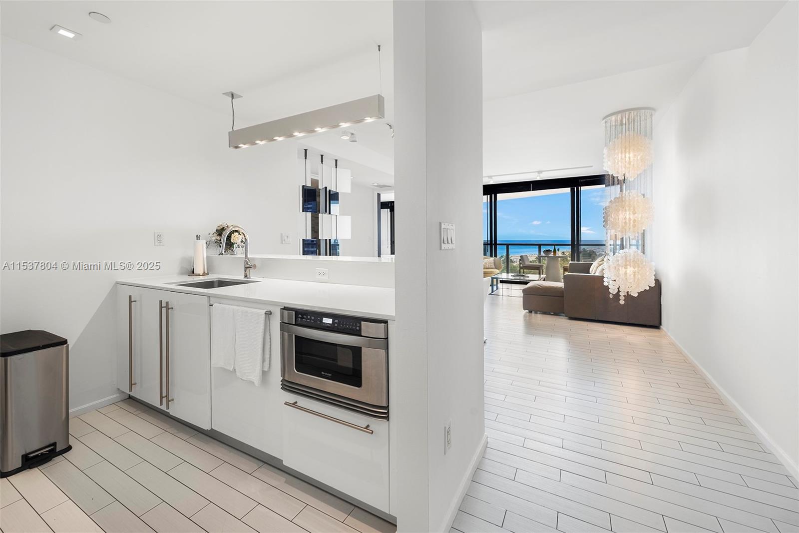 2201 Collins Avenue, Unit 814 Miami Beach, FL 33139 - Photo 13 of 32 a kitchen with stainless steel appliances a white stove top oven and sink