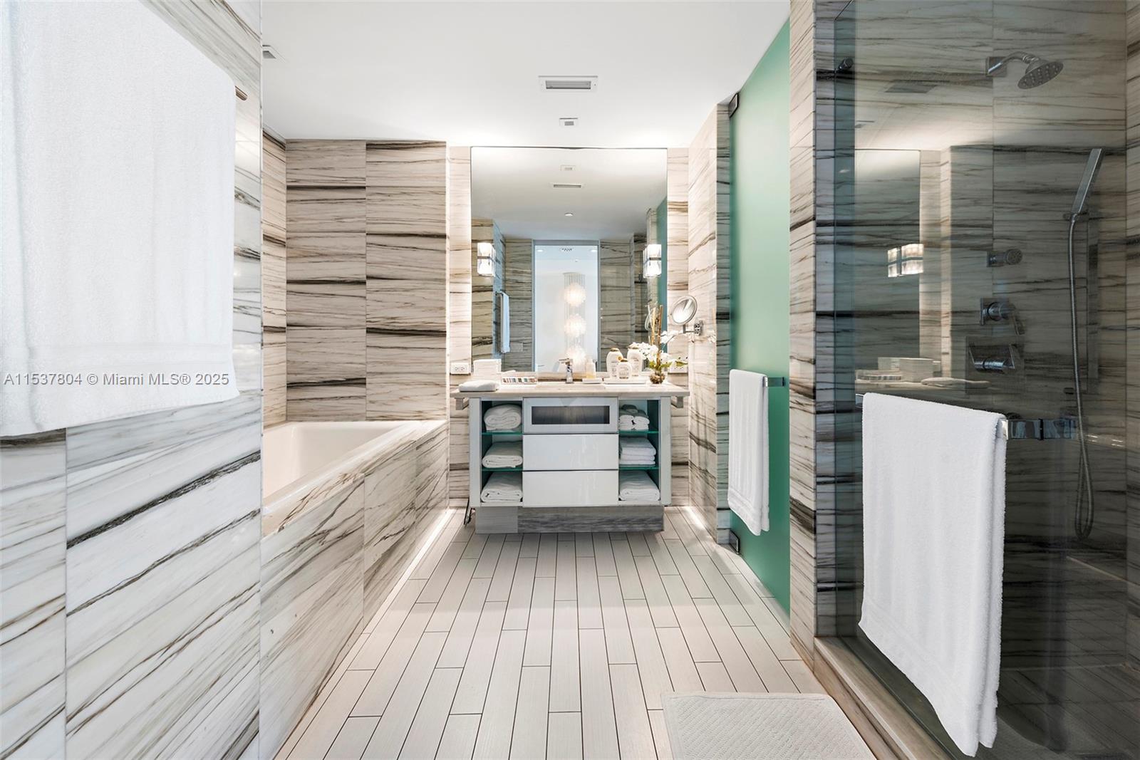 2201 Collins Avenue, Unit 814 Miami Beach, FL 33139 - Photo 21 of 32 a bathroom with a bathtub and a sink