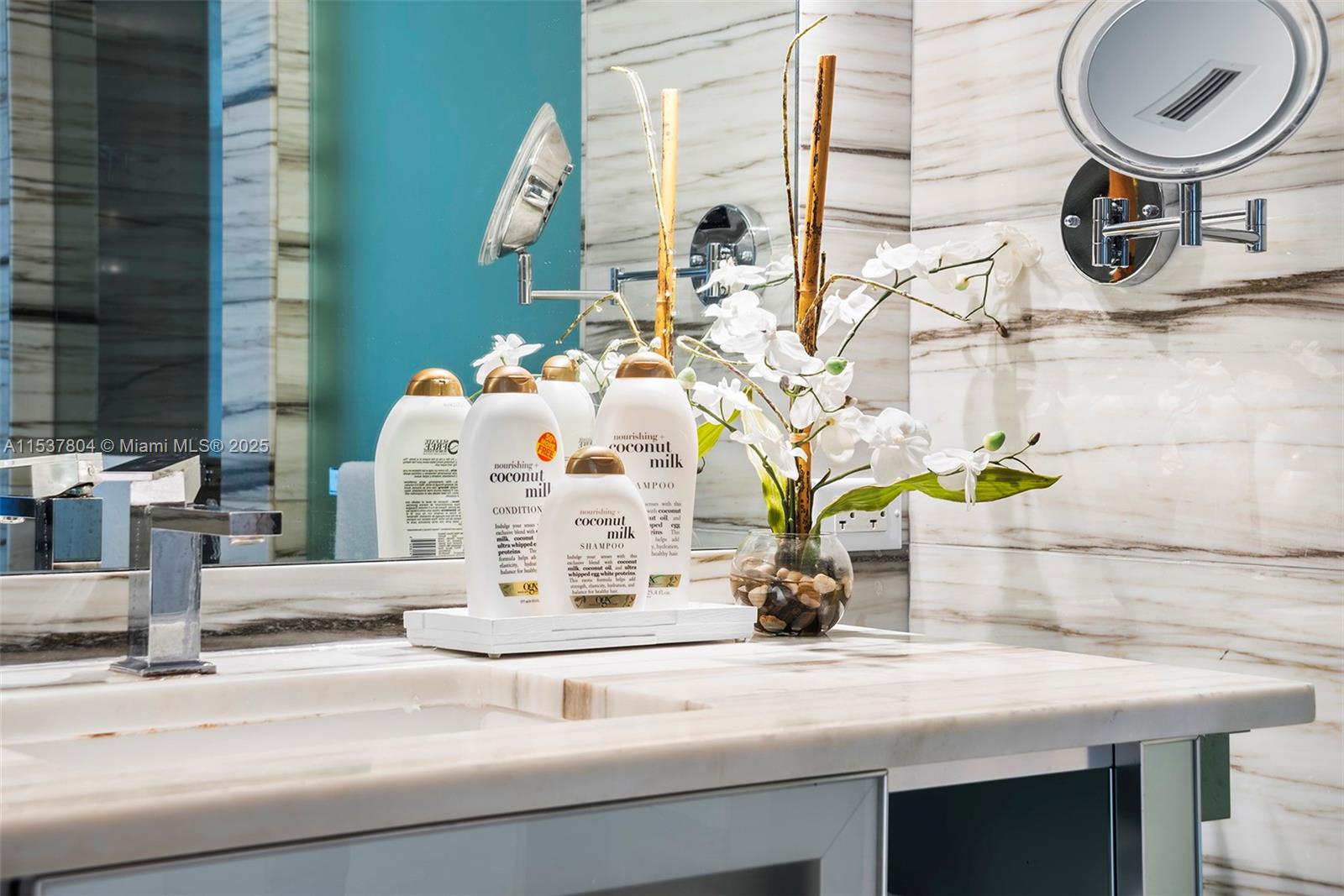 2201 Collins Avenue, Unit 814 Miami Beach, FL 33139 - Photo 24 of 32 a bathroom with a sink and a mirror