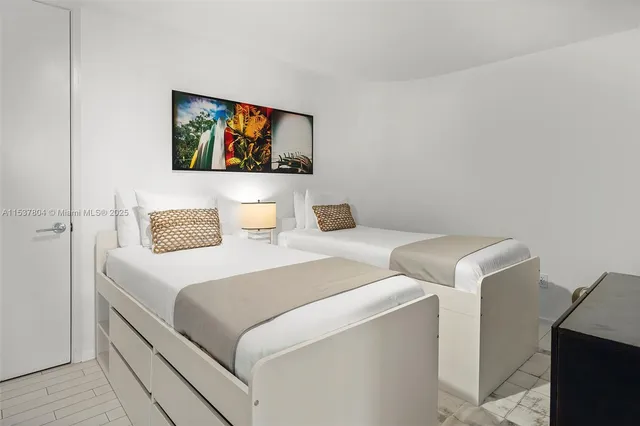 a bedroom with a bed and a painting on the wall