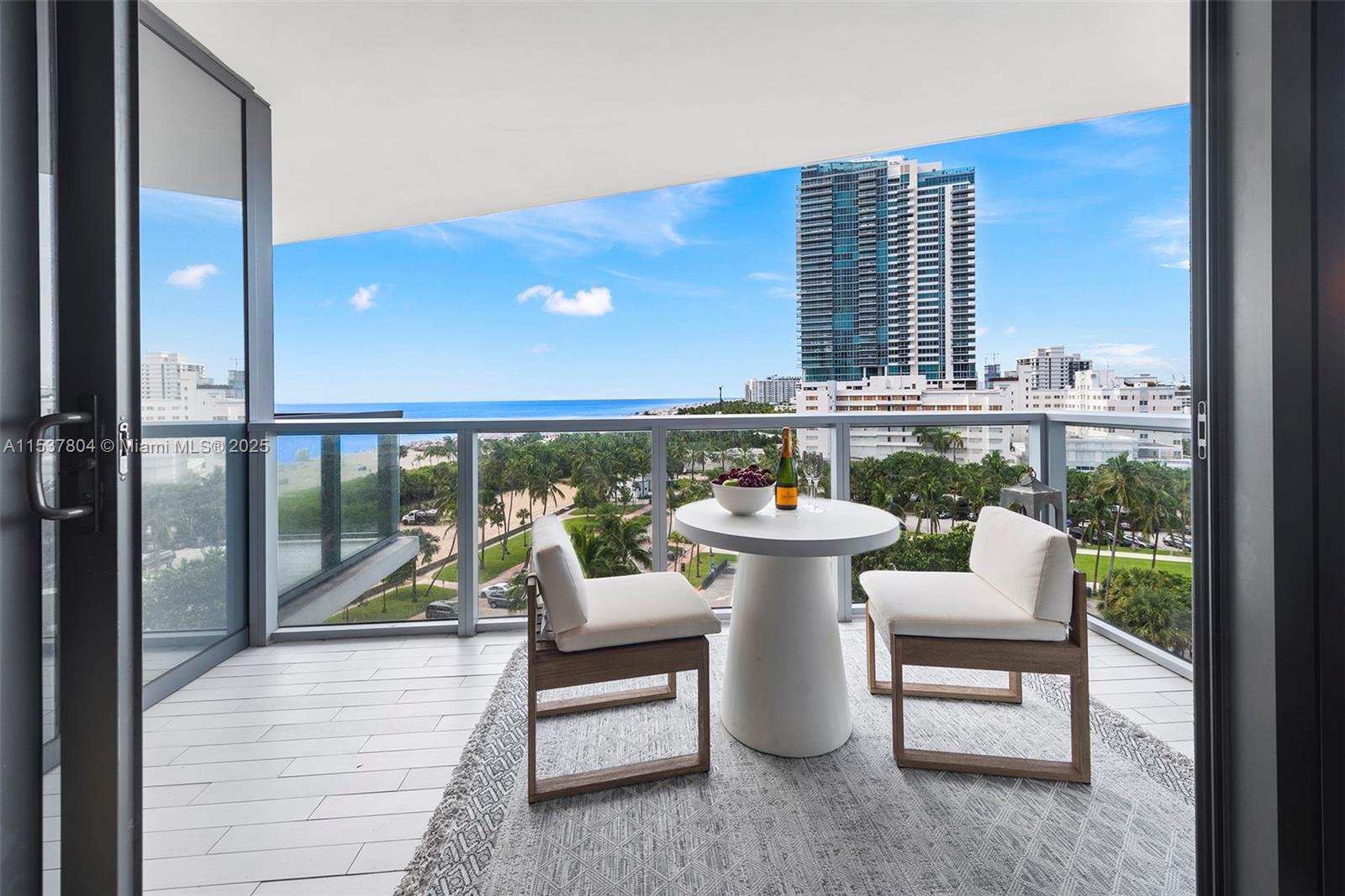 2201 Collins Avenue, Unit 814 Miami Beach, FL 33139 - Photo 28 of 32 a view of a chairs and table in the balcony