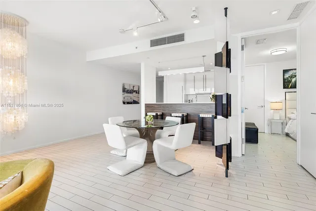 a large kitchen with a table and chairs