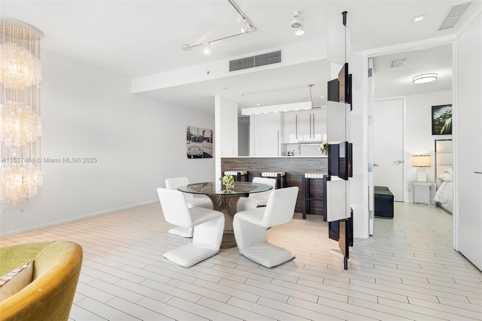 2201 Collins Avenue, Unit 814 Miami Beach, FL 33139 - Photo 4 of 32 a large kitchen with a table and chairs