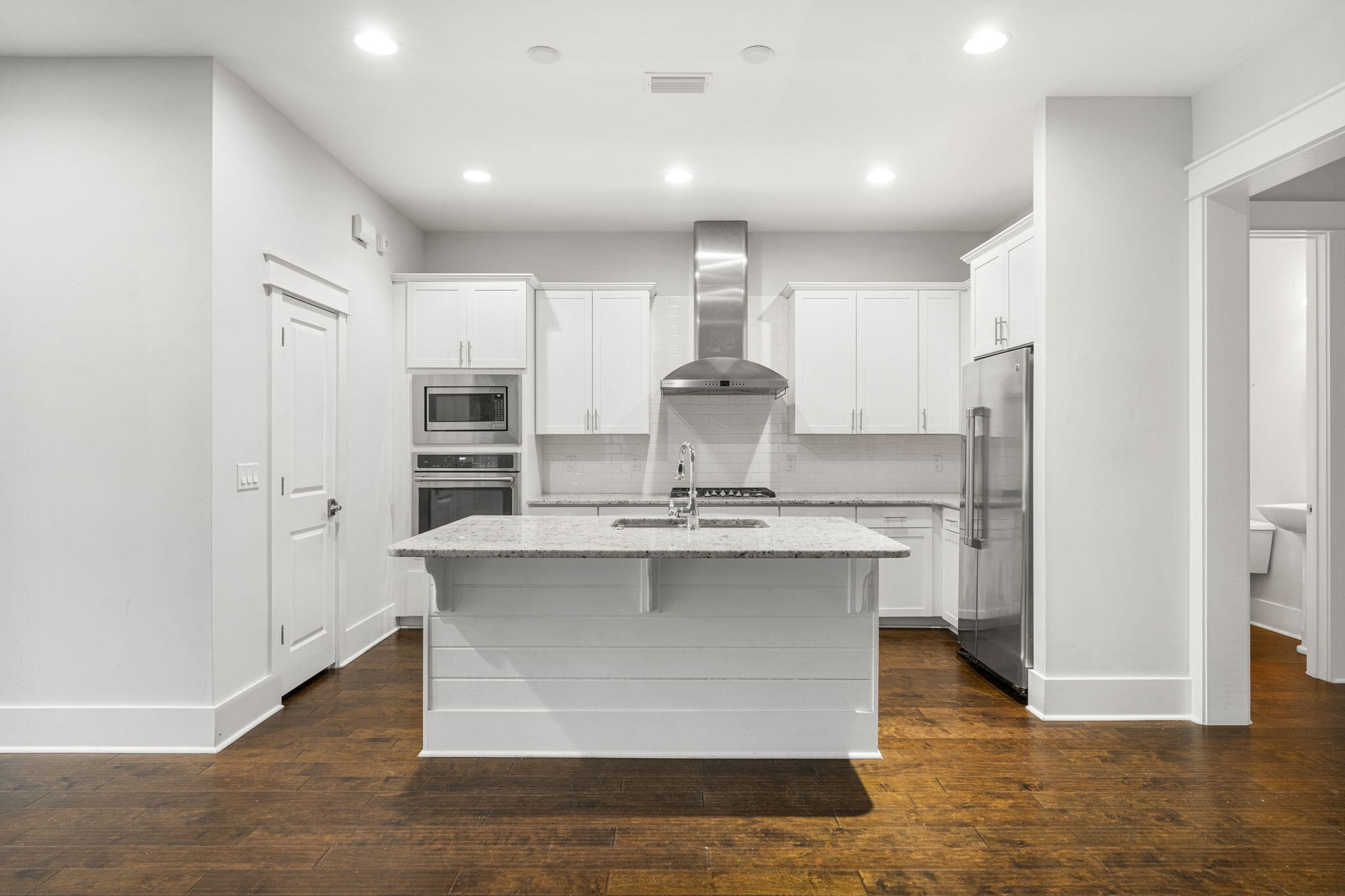 426 Flatwoods Forest Loop Santa Rosa Beach, FL 32459 - Photo 12 of 59 a kitchen with kitchen island a sink stove and refrigerator