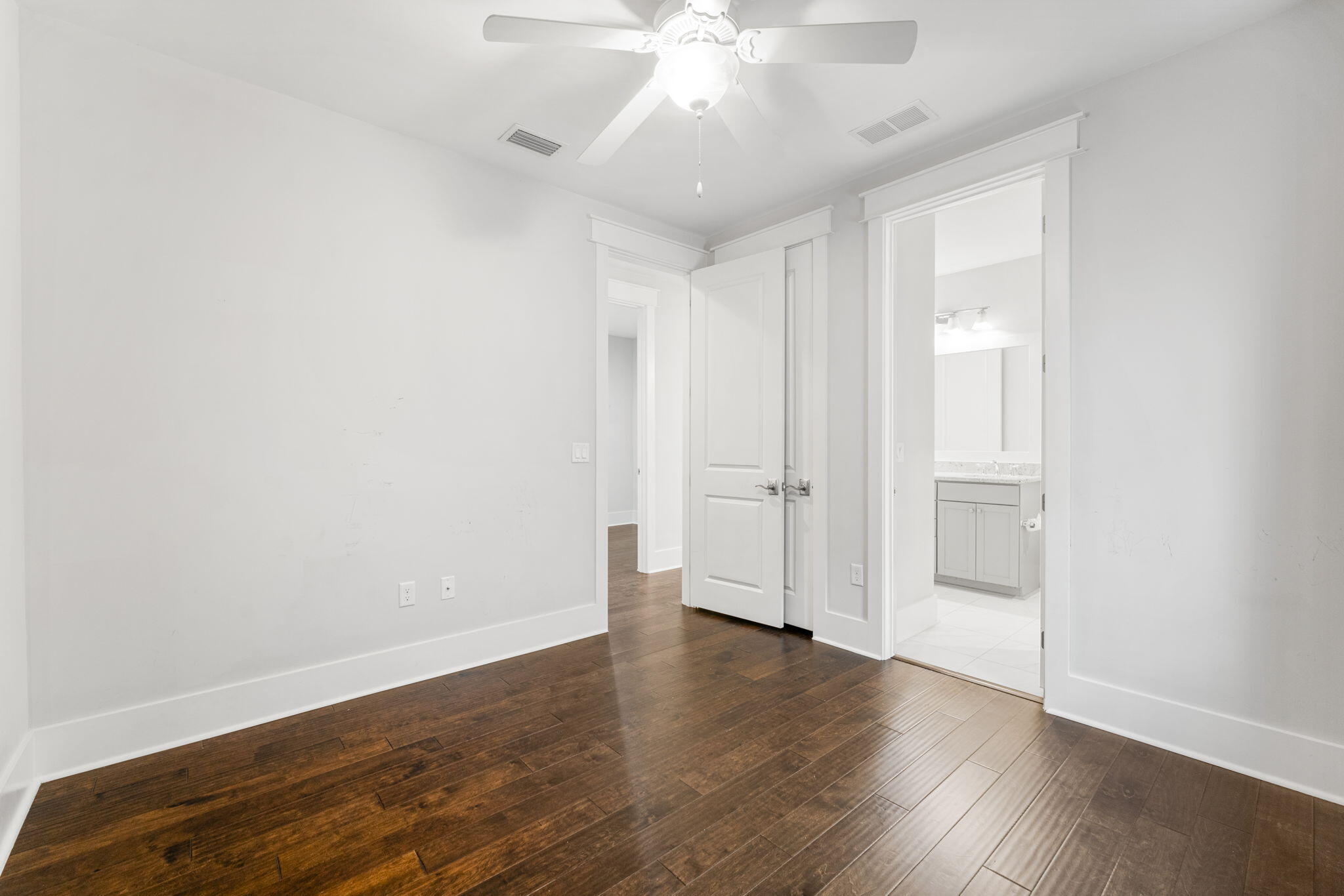 426 Flatwoods Forest Loop Santa Rosa Beach, FL 32459 - Photo 28 of 59 an empty room with wooden floor and windows