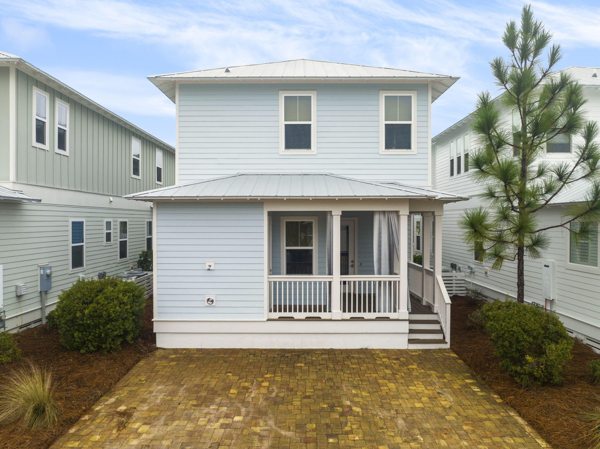 426 Flatwoods Forest Loop Santa Rosa Beach, FL 32459 - Photo 40 of 59 a view of a house with a large window and potted plants