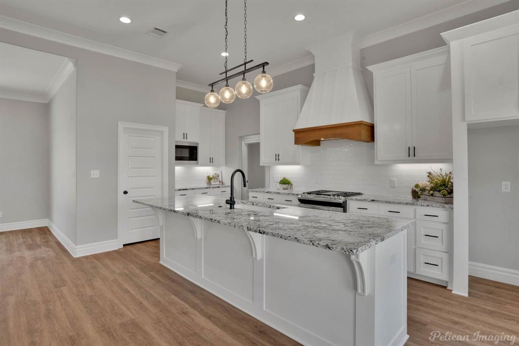 165 Oak Aly Road Stonewall, LA 71078 - Photo 15 of 36 a kitchen with stainless steel appliances granite countertop a sink a stove and a wooden floors