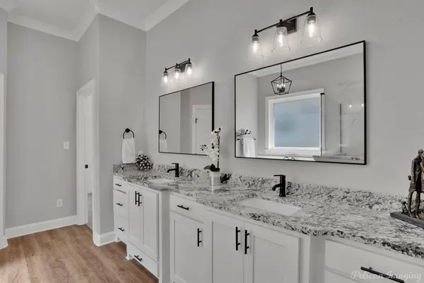 a bathroom with double sink and a mirror