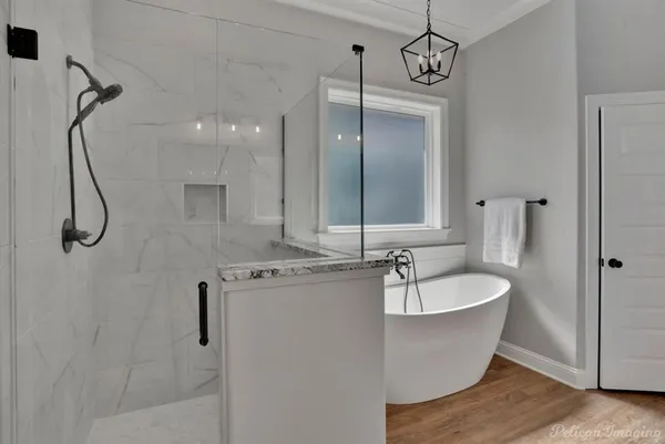 a bathroom with a sink mirror and a bathtub