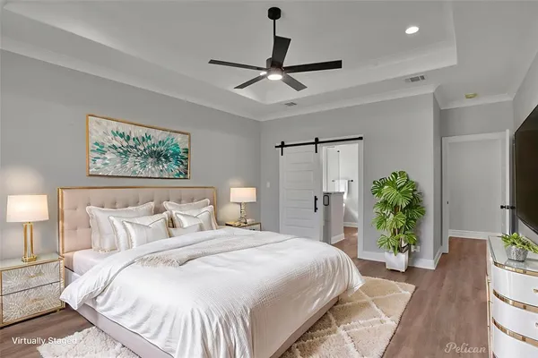 a bedroom with a large bed and a chandelier