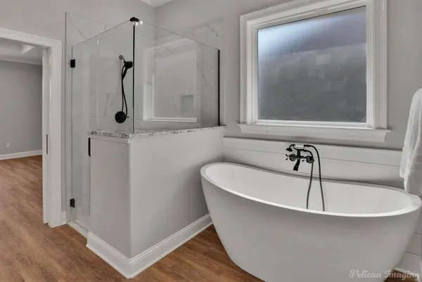 a bathroom with a bathtub and a shower