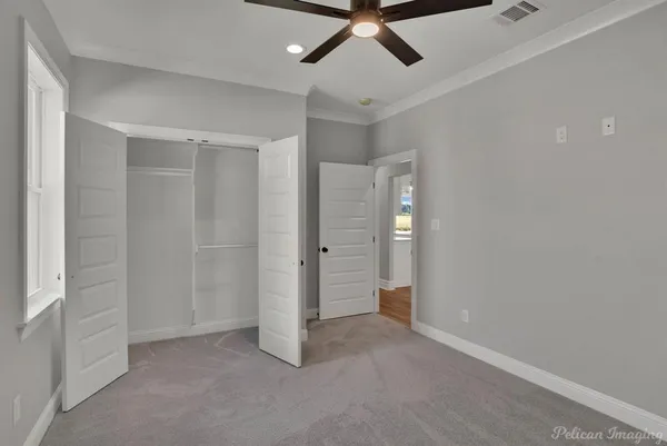 an empty room with a ceiling fan and shower
