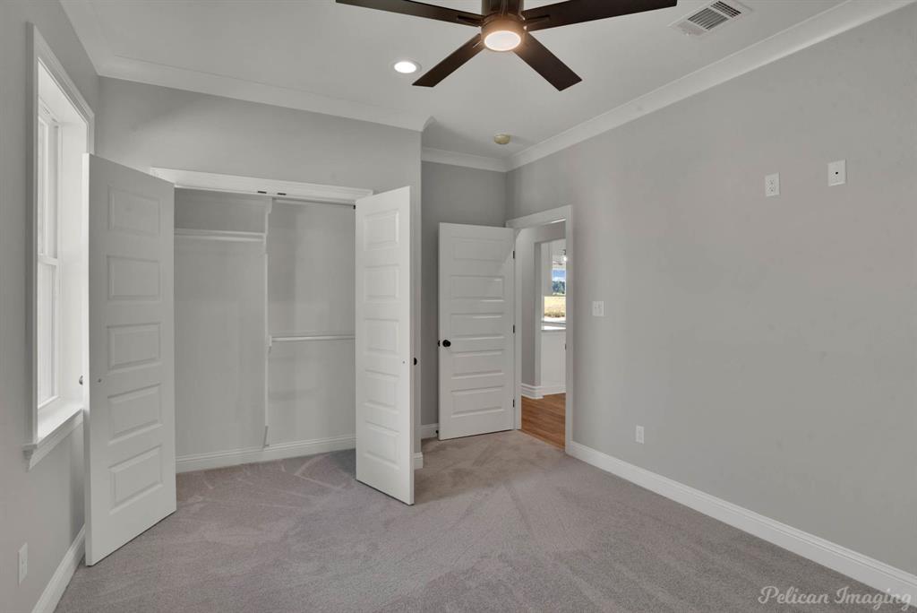 165 Oak Aly Road Stonewall, LA 71078 - Photo 28 of 36 an empty room with a ceiling fan and shower