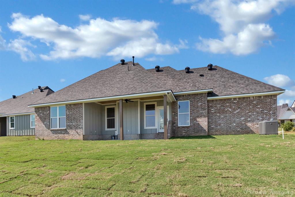 165 Oak Aly Road Stonewall, LA 71078 - Photo 31 of 36 a view of a house with brick walls plants and large tree