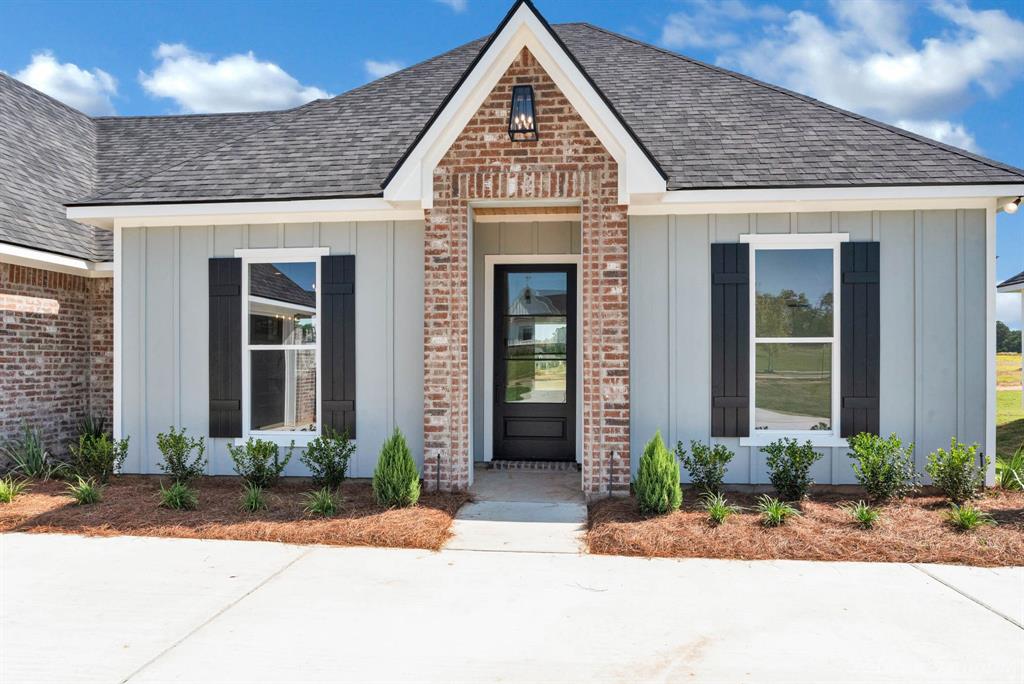165 Oak Aly Road Stonewall, LA 71078 - Photo 33 of 36 a view of a brick house with potted plants