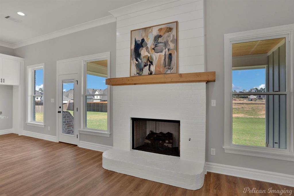 165 Oak Aly Road Stonewall, LA 71078 - Photo 9 of 36 a living room with a fireplace and a window