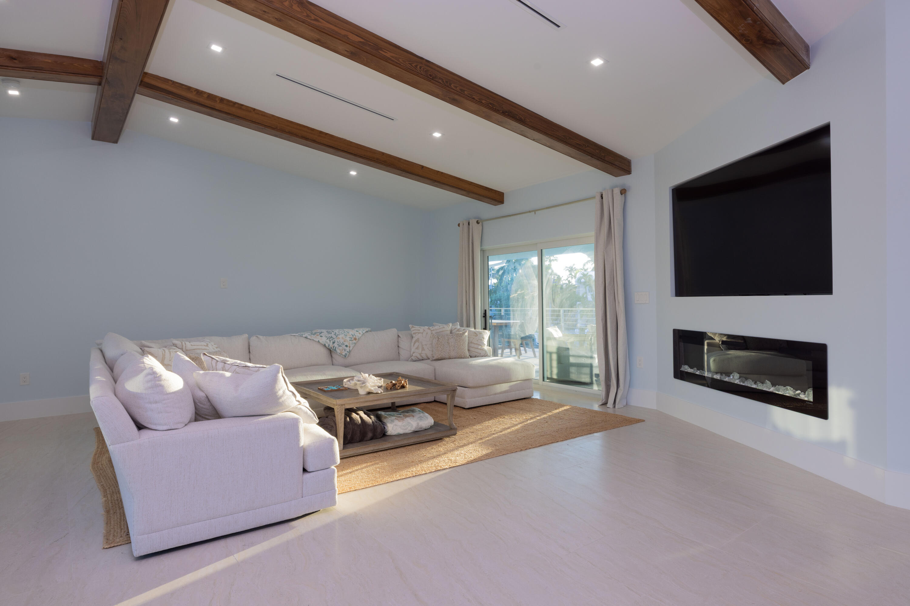 241 12th Street Key Colony Beach, FL 33051 - Photo 26 of 74 a living room with furniture a flat screen tv and a fireplace