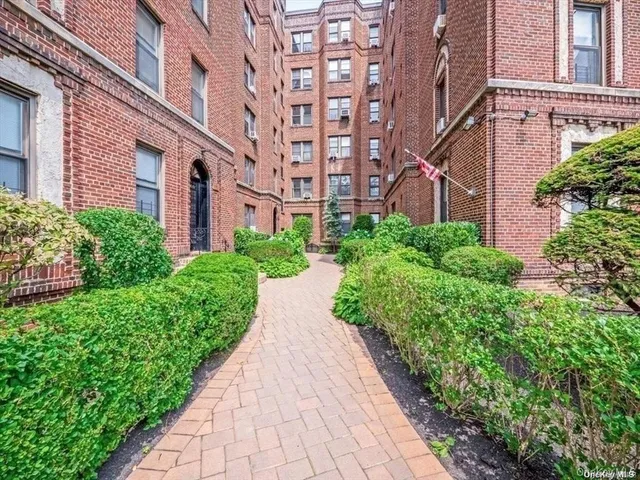 front view of a brick building with stairs