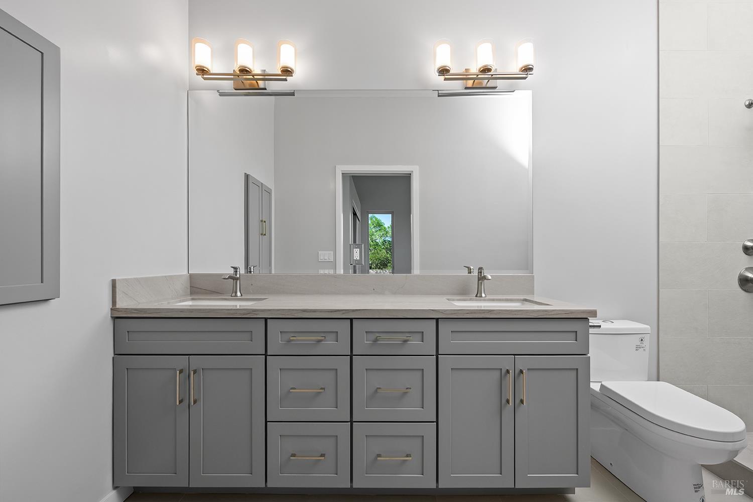 1292 Wikiup Drive Santa Rosa, CA 95403 - Photo 22 of 32 a bathroom with a granite countertop toilet sink and mirror