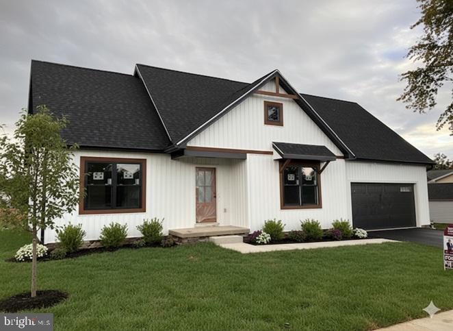 a front view of house with yard and green space