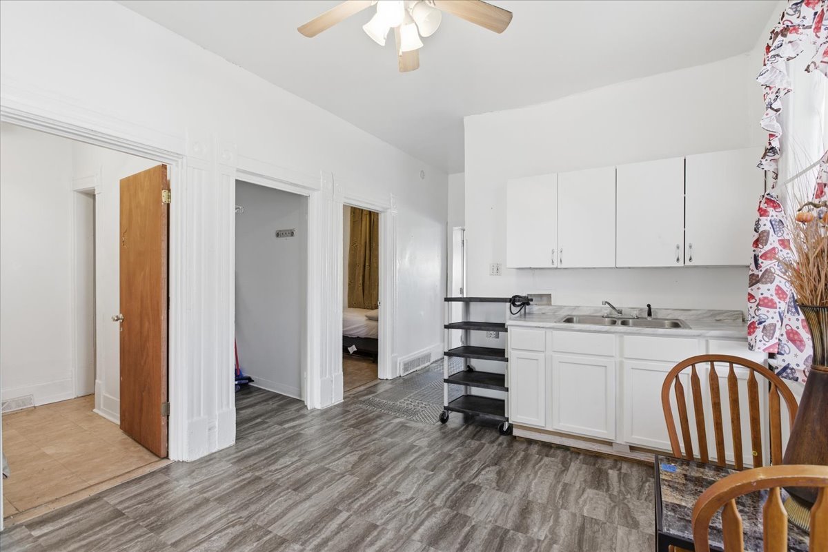 516 West 45th Place Chicago, IL 60609 - Photo 4 of 12 a kitchen with stainless steel appliances granite countertop a stove a sink and a refrigerator with wooden floors