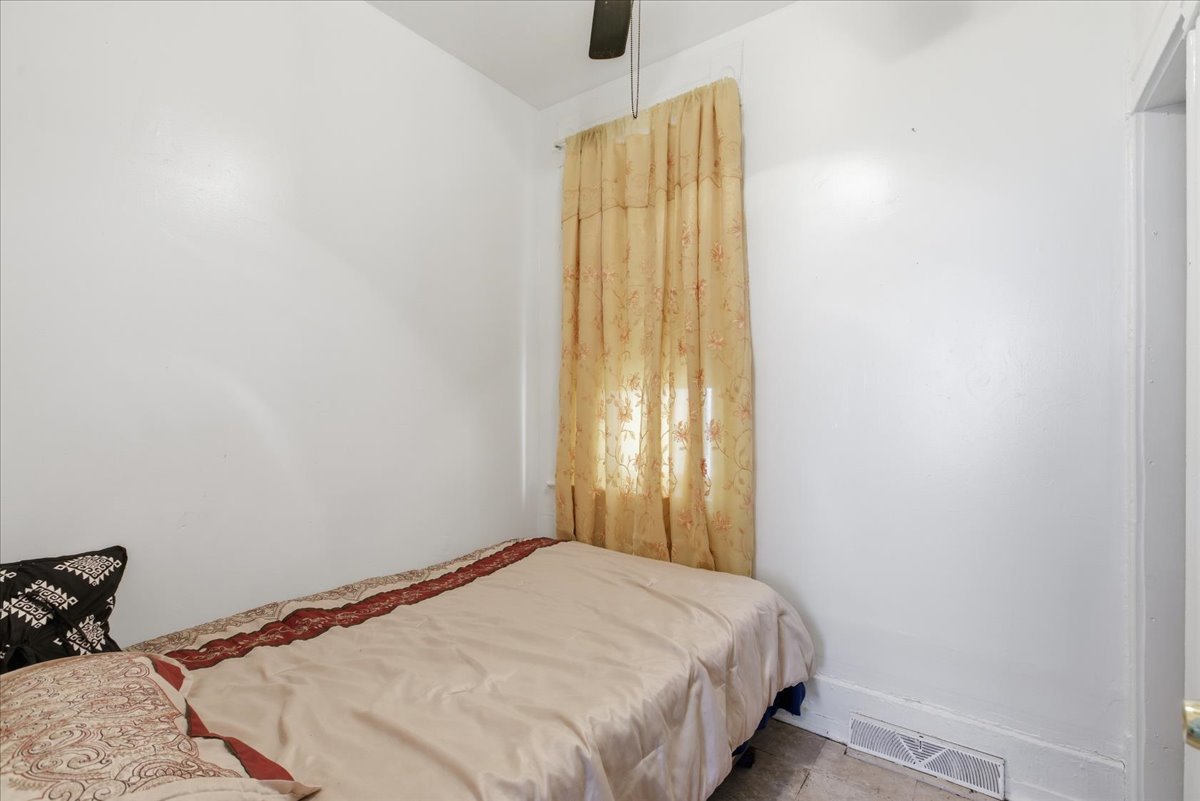 516 West 45th Place Chicago, IL 60609 - Photo 8 of 12 a bedroom with a bed and a window