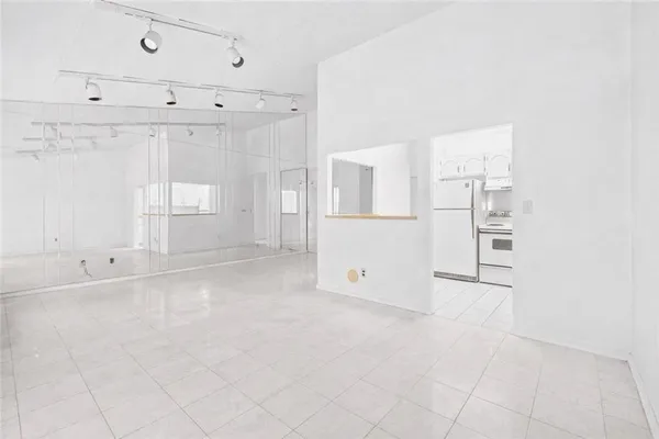 an empty room with windows and entrance