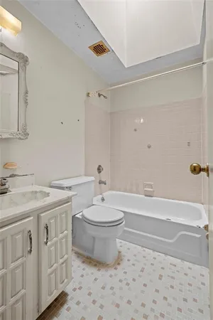 a bathroom with a sink a toilet and a mirror