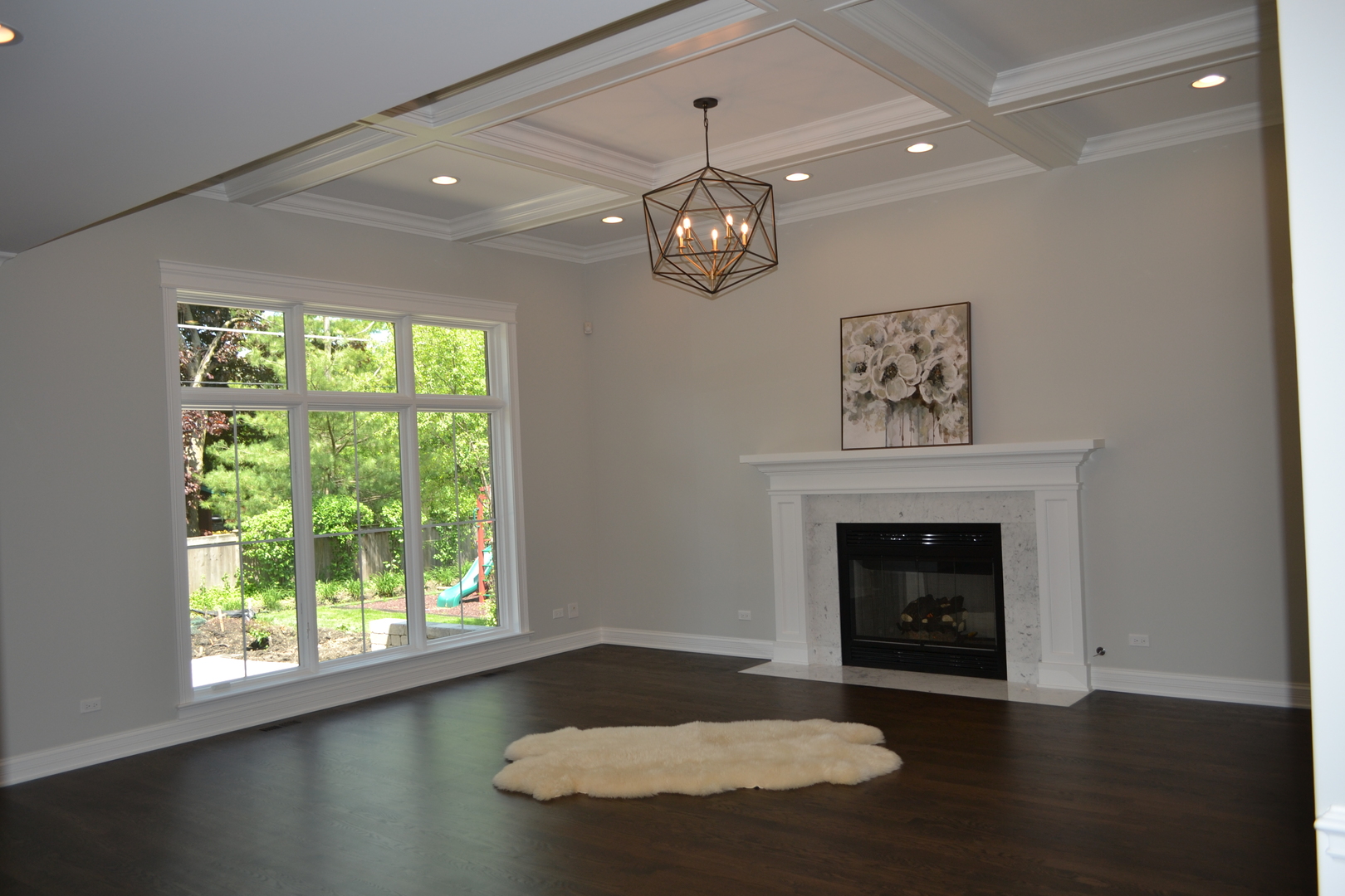 2247 Illinois Road Northbrook, IL 60062 - Photo 2 of 32 an empty room with wooden floor a fireplace and a window
